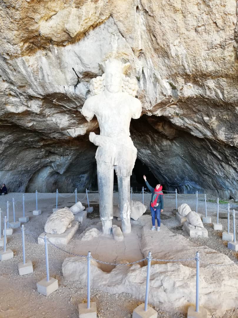 The Mysterious Shapour Cave. Compare the size of statue with the lady